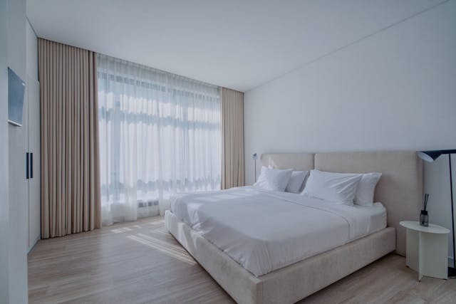 double bed in room with brown cupboards
