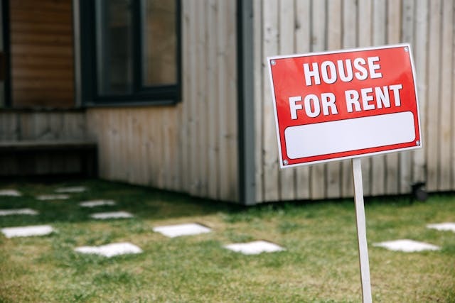 house for rent sign in front of house