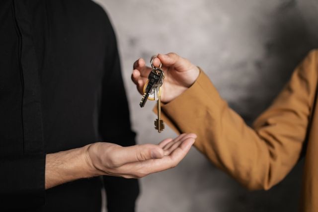 two people holding a set of keys