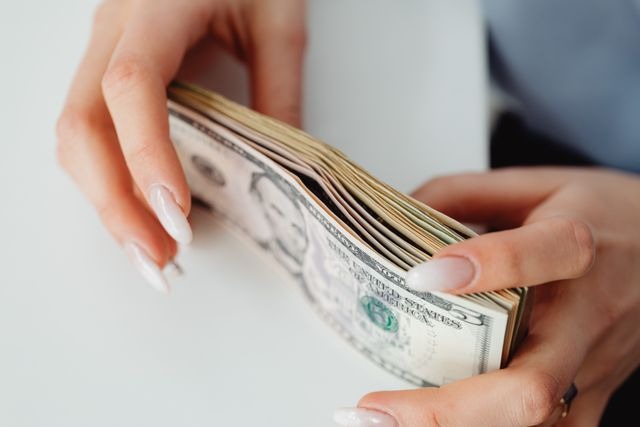 person holding stak of cash