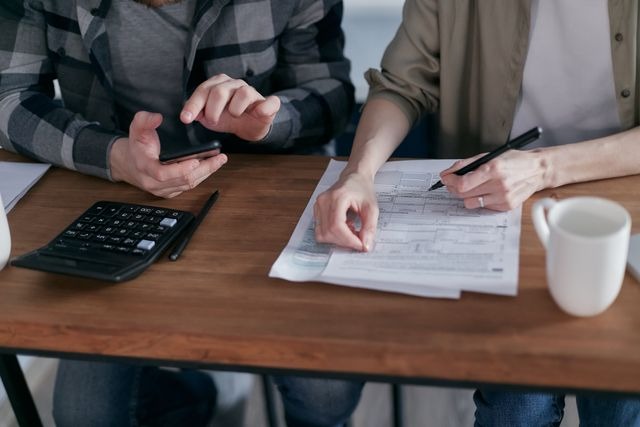 Two people doing taxes